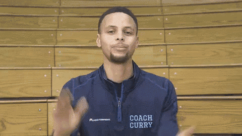a basketball player wearing a coach curry jacket is smiling