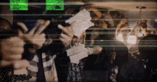 a group of people are standing in a room with their hands up .
