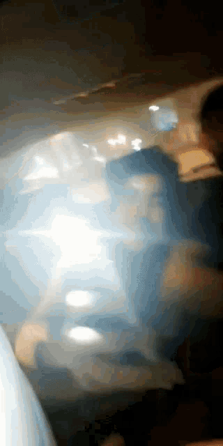 a blurry photo of a person 's face in a dark room