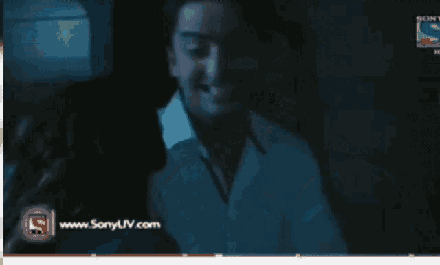 a man is smiling in front of a screen that says sony liv.com
