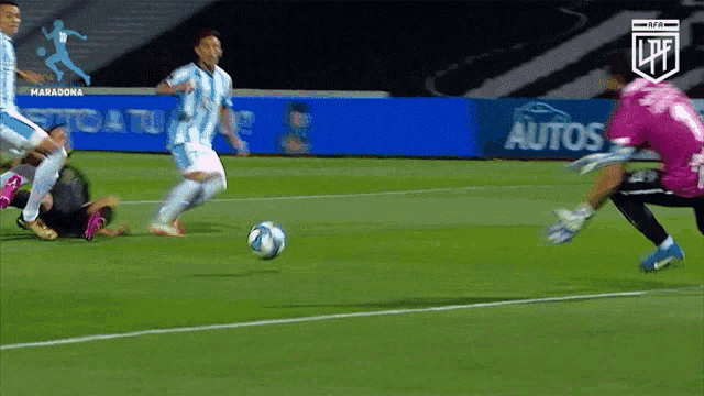 a soccer game is being played in front of a sign for autos