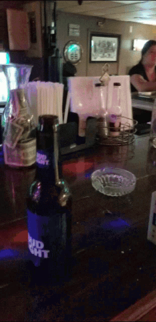 a bottle of bud light is on a bar