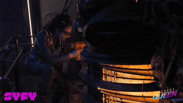 a poster for syfy shows a woman working on a device