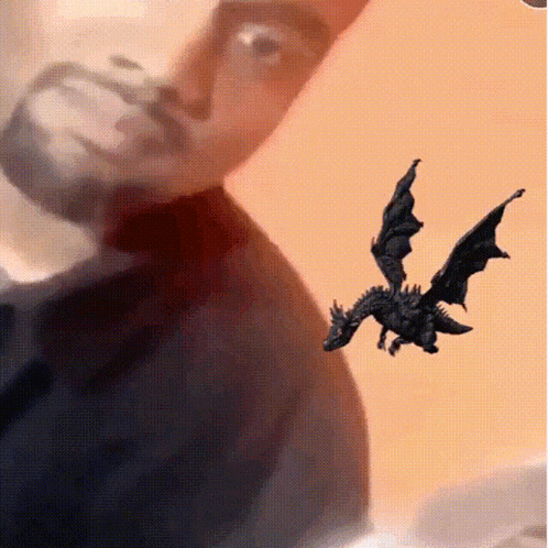 a dragon is flying in front of a man 's face .