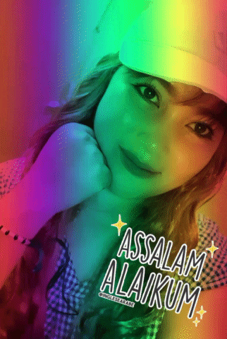 a girl wearing a white hat with the words assalamu alaikum written on it