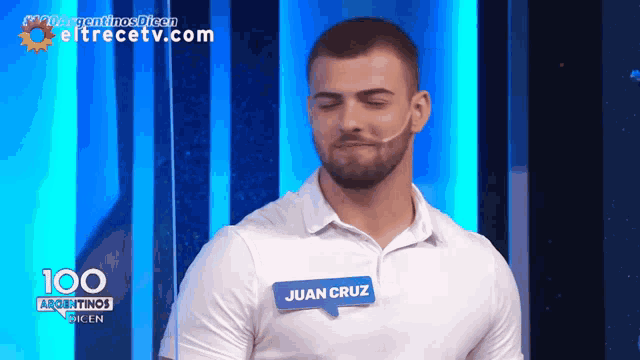 a man wearing a name tag that says juan cruz on it