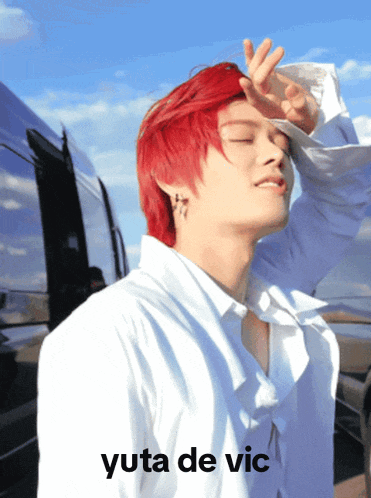 a man with red hair is wearing a white shirt and yuta de vic is written on the bottom