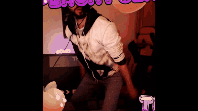 a man dancing in front of a sign that says xoxo