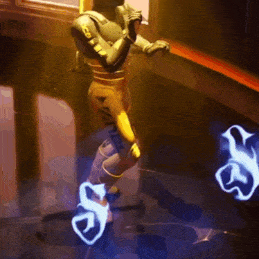 a man in a yellow suit is dancing in a dark room .