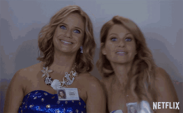 two women standing next to each other with a netflix logo on the bottom