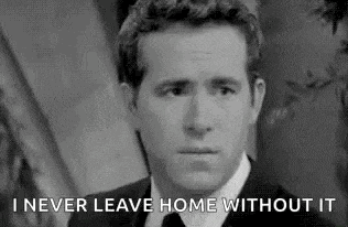 a black and white photo of a man in a suit and tie with the words `` i never leave home without it '' .
