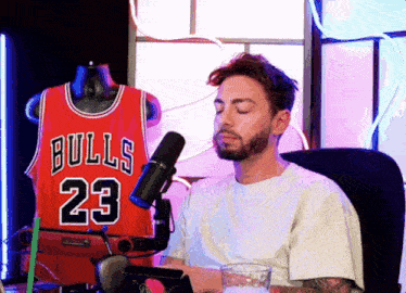 a man sitting in front of a bulls jersey