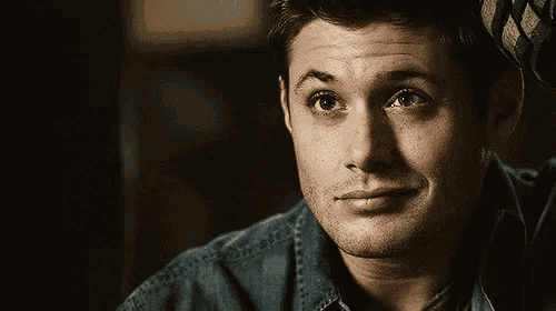 a close up of a man wearing a denim shirt