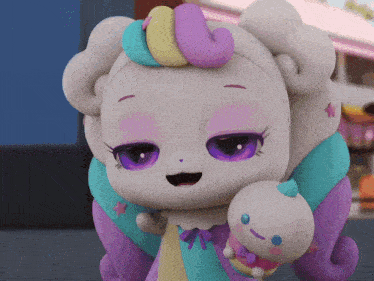 a stuffed animal with purple eyes is holding a baby
