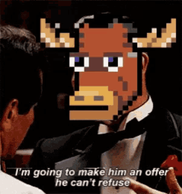 a man in a tuxedo is talking to a moose with antlers .