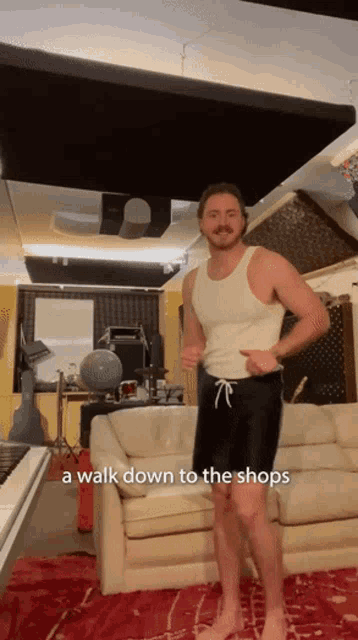 a man standing in front of a couch with the words " a walk down to the shops " written below him