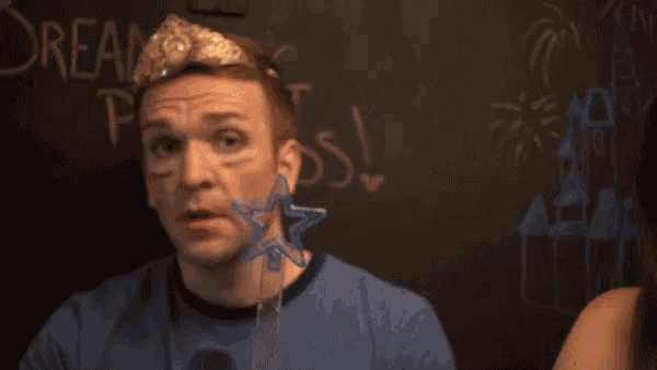a man with a crown on his head stands in front of a chalkboard that says dream princess