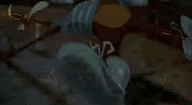 a green dinosaur is glowing in the dark in a dark room .