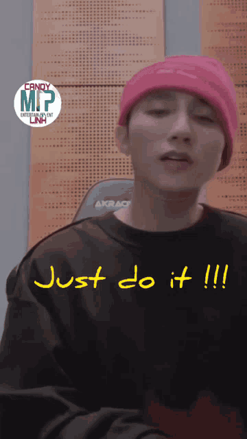 a man wearing a pink hat and a black shirt says just do it !!!