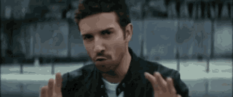 a man in a black leather jacket is making a funny face
