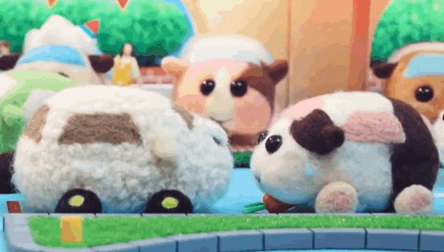 a group of stuffed animals are standing next to each other .