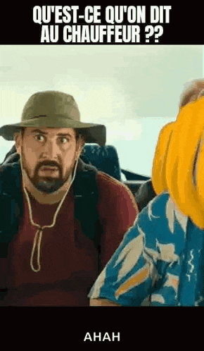 a man with a beard is wearing a hat and headphones on a bus .