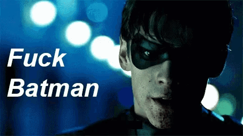 a man wearing a mask with the words fuck batman behind him