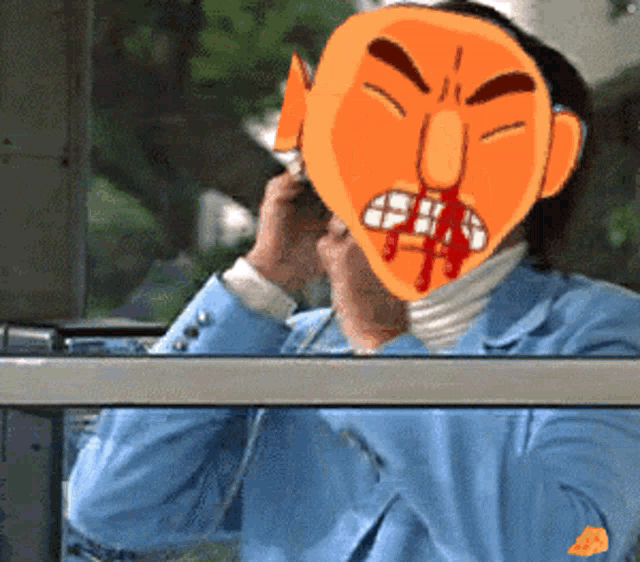 a man wearing a mask with blood coming out of his mouth is talking on a cell phone