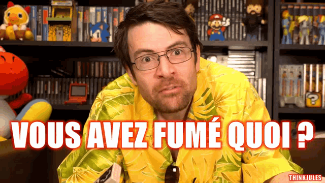 a man wearing glasses and a yellow shirt with the words vous avez fume quoi
