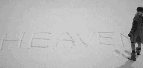 the word heaven is written in the snow by a snowboarder