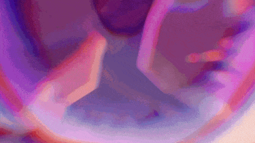 a close up of a purple and pink background with a swirl .