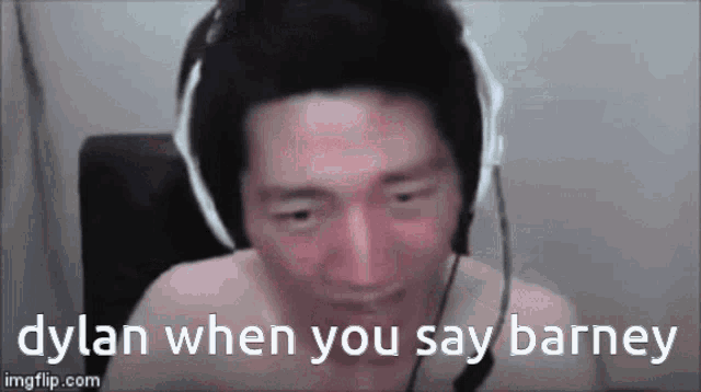 a shirtless man wearing headphones and a microphone is talking to someone .