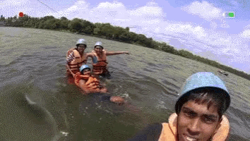 a group of people in a boat in the water
