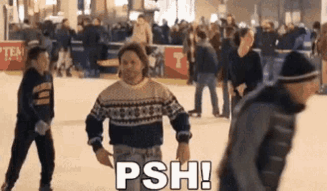 a man in a sweater is standing on an ice rink with the words psh written above him