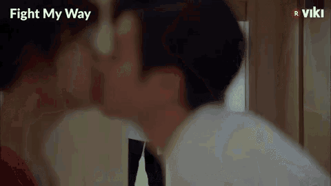 a man and a woman are kissing in a hallway in a fight my way episode .