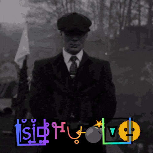 a man in a suit and tie stands in front of a sign that says ' tsish ' on it