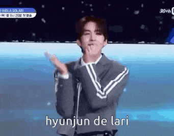 a man in a suit is applauding with the words hyunjun de lari written below him