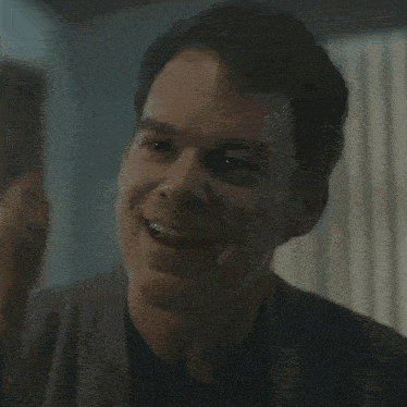 a close up of a man 's face with his eyes closed in a room .