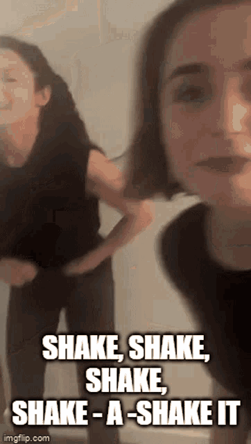a couple of women are standing next to each other and one of them is saying shake shake shake shake it