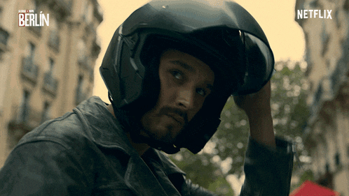a man wearing a helmet with a netflix logo in the background