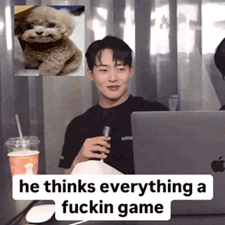 a man sitting in front of a laptop with the words he thinks everything a fuckin game underneath him