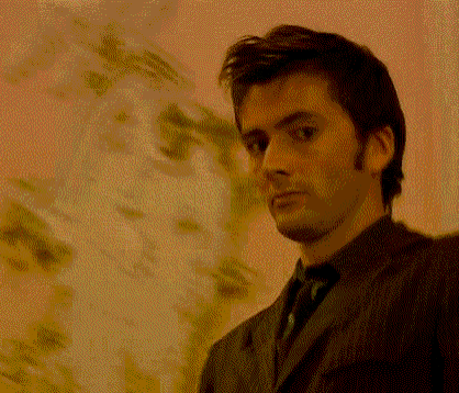 a man in a suit is smiling with his mouth open