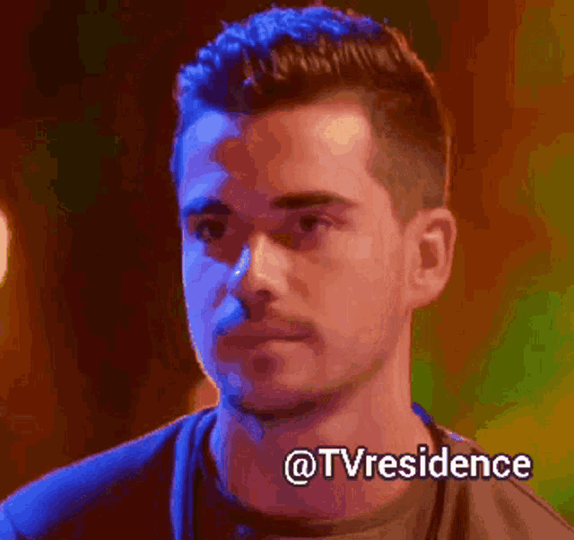 a close up of a man 's face with the words @tvresidence below it