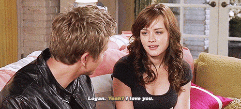 a man and a woman are sitting on a couch and the woman says " logan yeah i love you "