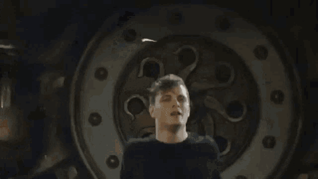 a man is dancing in front of a large wheel