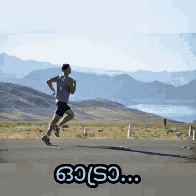 a man is running down a road with mountains in the background and the words go so ... below him