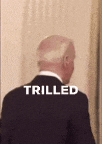 a man in a suit has the word trilled on his back .