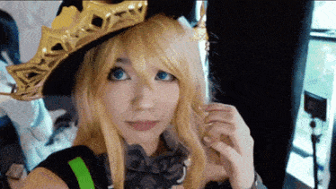 a woman with blonde hair and blue eyes is wearing a costume