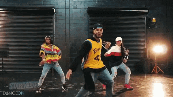 a man in a bears jersey is dancing with two other people
