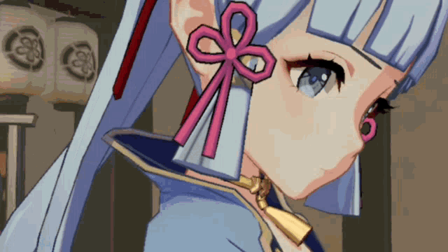 a close up of a girl 's face with a pink bow in her hair